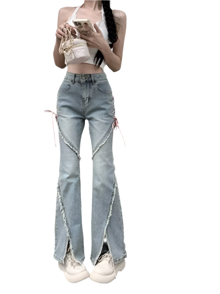 Person wearing high-waisted denim jeans with rips and a cutout design, standing in front of a mirror.