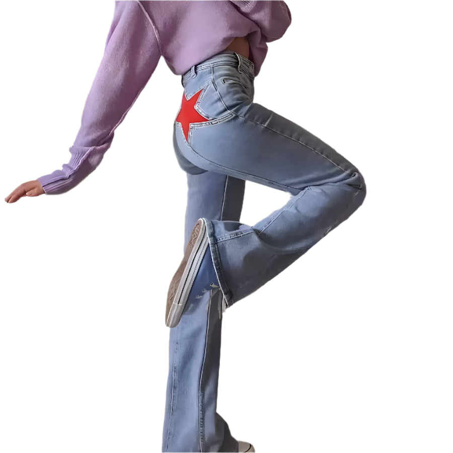 Person wearing a purple sweater and blue jeans with a red star design, standing in a room with decor elements.