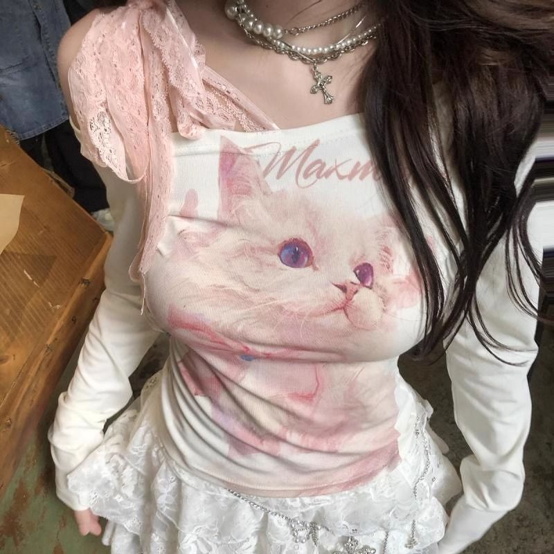 Person wearing a shirt with a cat design and 'Maxim' text